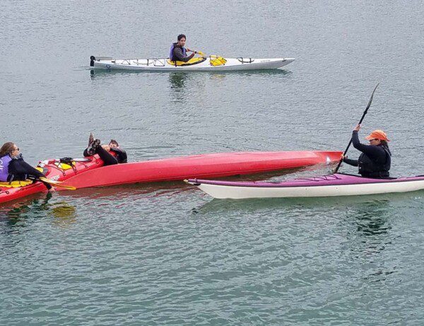 Sea Trek kayak rescue class where the students are learning advanced techniques of how to upright a kayak in open water.