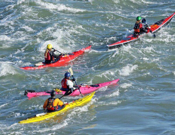 Kayakers learning to navigate rougher waters with the Angel Island Skills Package - offered at Sea Trek