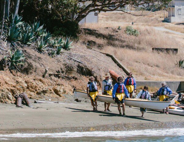 kayaks putting their boats back in at angel island