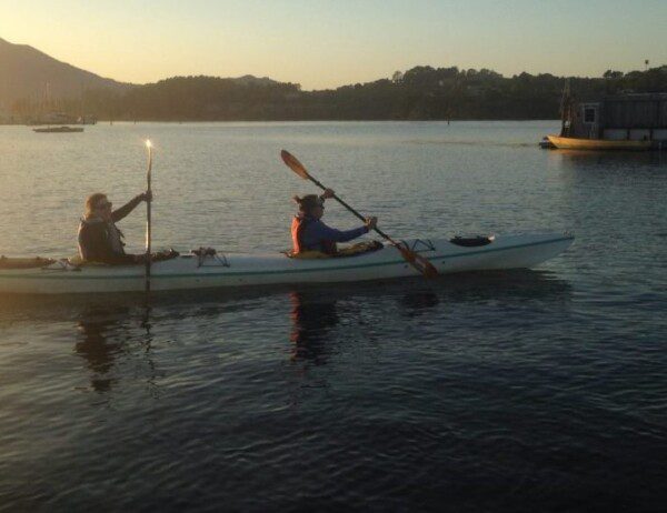 tandem sea kayaking at sunset