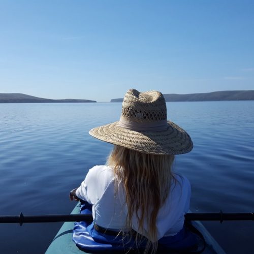 Drakes Estero-Website A sole kayaker on a beautiful day paddling out to Drakes Estero on a guided kayaking tour