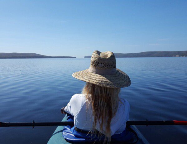 A sole kayaker on a beautiful day paddling out to Drakes Estero on a guided kayaking tour