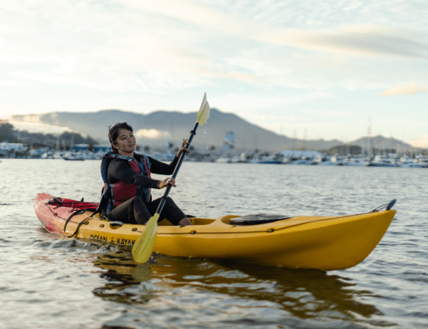 Lady learning how to paddle her sit on top kayak through the waters of Richardson Bay by Sausalito, CA