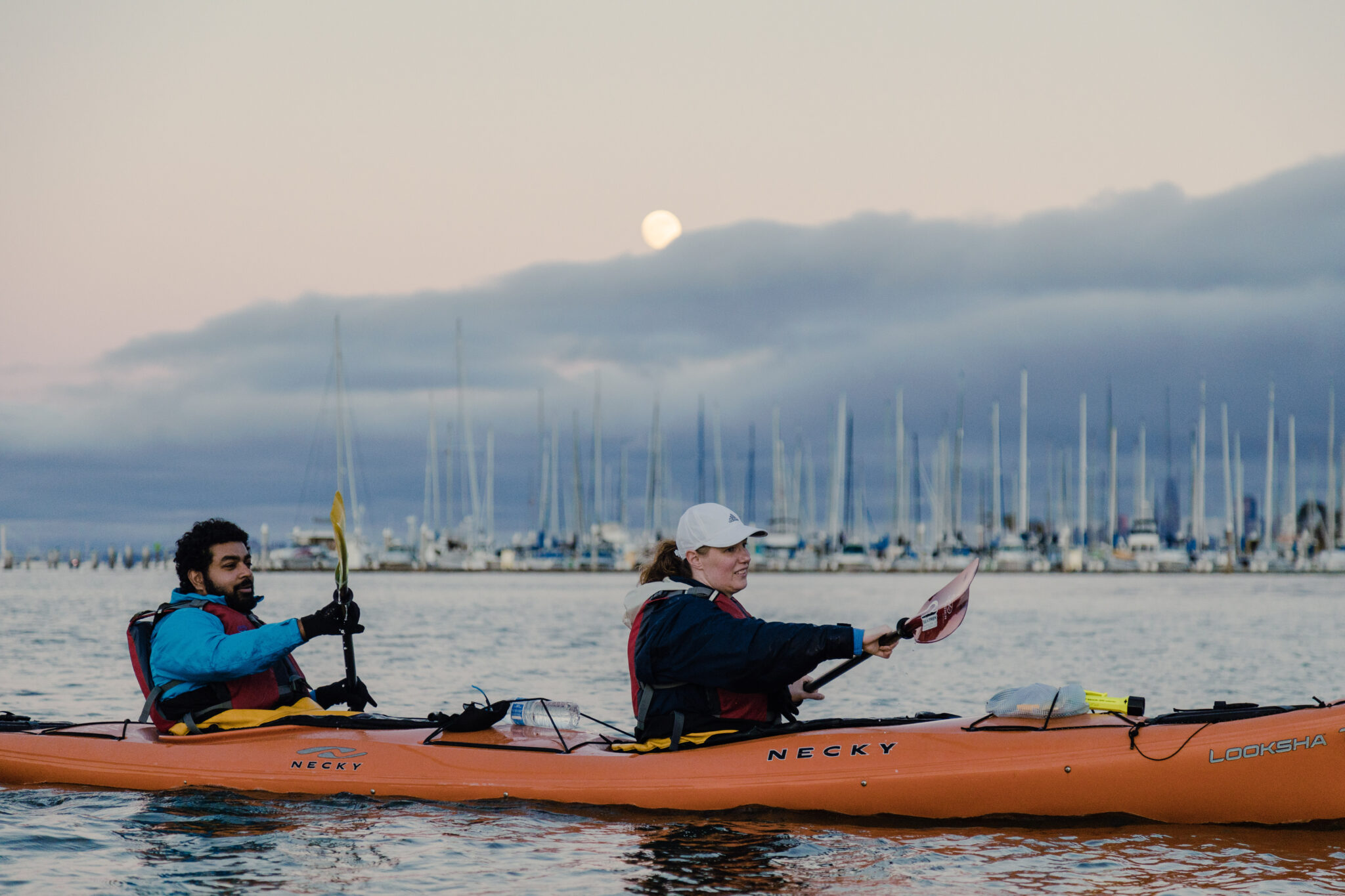 couple kayaks outside of San Francisco beneath a full moon