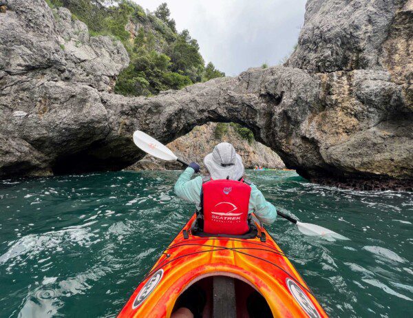 kayaking under a natural arch